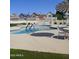 Community pool featuring a ladder for entering and lounge chairs for relaxing at 16513 N 68Th Dr, Peoria, AZ 85382