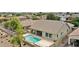Aerial view of a private pool and backyard with patio, surrounded by lush greenery and fencing at 1694 E Mia Ln, Gilbert, AZ 85298