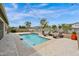 Inviting backyard pool with travertine decking, lounge chairs, and string lights at 1694 E Mia Ln, Gilbert, AZ 85298