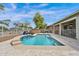 Lush backyard with a pool, spa, lounge chairs, and string lights; great for entertaining at 1694 E Mia Ln, Gilbert, AZ 85298