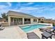 Gorgeous backyard pool area with sun deck, lounge chairs, and covered patio at 1694 E Mia Ln, Gilbert, AZ 85298