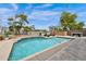 Beautiful backyard pool with Baja shelf, surrounded by travertine decking and landscaping at 1694 E Mia Ln, Gilbert, AZ 85298