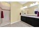 Bathroom with tile floors, double sinks, and tiled walk-in shower at 1694 E Mia Ln, Gilbert, AZ 85298