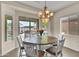 Cozy dining area with a round table and views of the backyard pool through sliding glass doors at 1694 E Mia Ln, Gilbert, AZ 85298