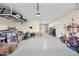 Spacious garage with ample storage shelving, coated concrete flooring, and organization systems at 1694 E Mia Ln, Gilbert, AZ 85298
