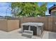Backyard hot tub area with a patio and privacy fence; perfect for relaxing at 1694 E Mia Ln, Gilbert, AZ 85298