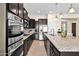 Bright kitchen featuring stainless steel appliances, granite countertops and dark cabinetry at 1694 E Mia Ln, Gilbert, AZ 85298