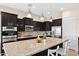 Stylish kitchen with dark cabinets, granite countertops, stainless steel appliances, and modern lighting at 1694 E Mia Ln, Gilbert, AZ 85298