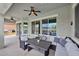 Inviting covered patio with elegant wicker seating, ceiling fan and view of the pool at 1694 E Mia Ln, Gilbert, AZ 85298