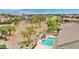 Aerial view of a home featuring a private backyard pool, deck area, and mature trees at 1694 E Mia Ln, Gilbert, AZ 85298