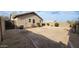 Large backyard with stone landscape, privacy wall, and desert vegetation at 17151 W Mohave St, Goodyear, AZ 85338