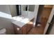 Another bathroom view with double sinks and vanity, neutral paint, and an adjacent room at 17151 W Mohave St, Goodyear, AZ 85338