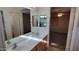 Bright bathroom with double sinks, vanity storage, and mirror that shows part of the main bedroom at 17151 W Mohave St, Goodyear, AZ 85338