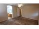 Comfortable bedroom with neutral carpeting, open ensuite, and plenty of natural light at 17151 W Mohave St, Goodyear, AZ 85338