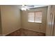 This bedroom features carpeted floor, ceiling fan, neutral walls, and a window with blinds at 17151 W Mohave St, Goodyear, AZ 85338