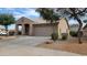 Charming single-story home with a low-maintenance landscaped front yard and an attached two-car garage at 17151 W Mohave St, Goodyear, AZ 85338