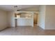 Open-concept living room with tiled floors, neutral paint, and an open view into adjacent rooms at 17151 W Mohave St, Goodyear, AZ 85338