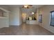 Spacious living area featuring tiled flooring, neutral paint, and great sight lines to the kitchen at 17151 W Mohave St, Goodyear, AZ 85338