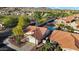 Aerial view of the home showcasing a backyard with pool, desert landscaping and mature trees, nestled in a desert community at 2218 E Desert Trumpet Rd, Phoenix, AZ 85048