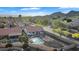 Aerial view of the home showcasing a large backyard with pool, desert landscaping and mature trees, nestled in a desert community at 2218 E Desert Trumpet Rd, Phoenix, AZ 85048