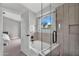 Bathroom featuring a tub with a tile surround and glass partition near the bedroom at 2218 E Desert Trumpet Rd, Phoenix, AZ 85048