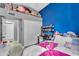Bedroom offering a brightly painted accent wall and a storage space above the closet at 2218 E Desert Trumpet Rd, Phoenix, AZ 85048