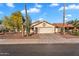 Charming single-story home features a tile roof, desert landscaping, and a two-car garage at 2218 E Desert Trumpet Rd, Phoenix, AZ 85048