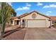 Well-maintained single-story house with a tile roof, two-car garage, and desert landscaping at 2218 E Desert Trumpet Rd, Phoenix, AZ 85048