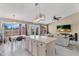 Open kitchen and dining area features an island with barstool seating and direct backyard views at 2218 E Desert Trumpet Rd, Phoenix, AZ 85048