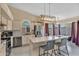 Bright kitchen featuring modern appliances, tile backsplash, a breakfast bar, and a dining area at 2218 E Desert Trumpet Rd, Phoenix, AZ 85048