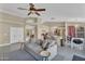 Open concept living area featuring kitchen island, living room with ceiling fan, and dining area at 2218 E Desert Trumpet Rd, Phoenix, AZ 85048