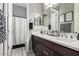 Bathroom with single sink, granite countertop, dark cabinetry, and tub/shower combo at 22434 S 226Th Pl, Queen Creek, AZ 85142
