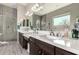 Modern bathroom with dual sinks, sleek cabinets, quartz countertop, and stylish tile shower at 22434 S 226Th Pl, Queen Creek, AZ 85142