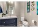 Half-bathroom with blue vanity, updated fixtures, and eye-catching decor at 22434 S 226Th Pl, Queen Creek, AZ 85142