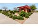 Lush community landscaping with shrubs and a trellis under a partly cloudy sky at 22434 S 226Th Pl, Queen Creek, AZ 85142