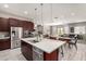 Open concept kitchen with stainless steel appliances and views into the living and dining areas at 22434 S 226Th Pl, Queen Creek, AZ 85142