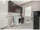 Well-lit laundry room with washer, dryer, upper cabinets and a window at 22434 S 226Th Pl, Queen Creek, AZ 85142