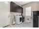 Spacious laundry room with washer, dryer, and ample cabinet storage at 22434 S 226Th Pl, Queen Creek, AZ 85142