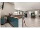 Open living space with a kitchenette area, bar seating, and tiled floors at 22434 S 226Th Pl, Queen Creek, AZ 85142