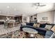 Open floor plan living space with kitchen, dining and living rooms, colorful area rug, and ceiling fan at 22434 S 226Th Pl, Queen Creek, AZ 85142