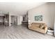 Bright living space with neutral walls with light wood-look flooring and view to dining and kitchen areas at 22434 S 226Th Pl, Queen Creek, AZ 85142