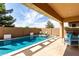 Backyard pool with seating, privacy wall, and patio at 22434 S 226Th Pl, Queen Creek, AZ 85142