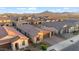 Aerial view showcasing a single-Gathering house and other suburban homes with mountain views at 22473 E Twilight Dr, Queen Creek, AZ 85142