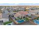 Aerial view showcasing a modern home with a pool and patio in a residential neighborhood at 22473 E Twilight Dr, Queen Creek, AZ 85142