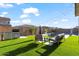 Backyard with artificial grass, outdoor seating, grill, and a pool, offering a relaxing and fun space at 22473 E Twilight Dr, Queen Creek, AZ 85142