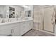 Elegant bathroom with double sinks, a glass-enclosed shower, and modern fixtures at 22473 E Twilight Dr, Queen Creek, AZ 85142