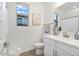 Bright bathroom with a white vanity, modern fixtures, and a window for natural light at 22473 E Twilight Dr, Queen Creek, AZ 85142