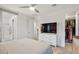 Spacious bedroom with a large TV, walk-in closet, and ensuite bathroom at 22473 E Twilight Dr, Queen Creek, AZ 85142