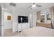 Bright bedroom with a large TV, neutral colors, and a view of the exterior at 22473 E Twilight Dr, Queen Creek, AZ 85142