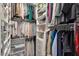 Organized walk-in closet with clothes neatly arranged on shelves and hanging rods, featuring seasonal wear at 22473 E Twilight Dr, Queen Creek, AZ 85142